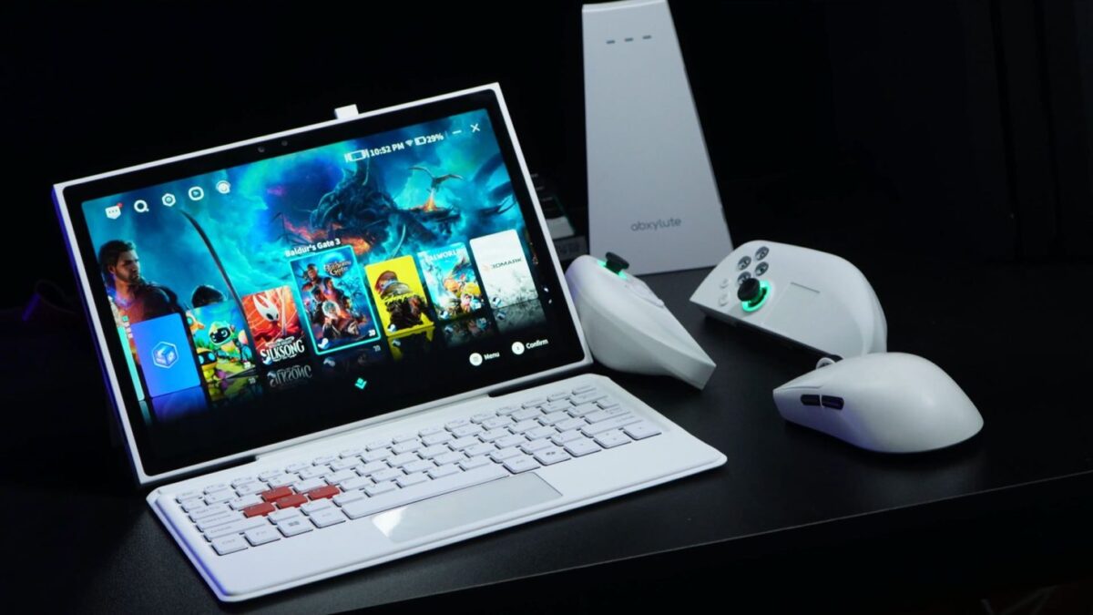 نمایی از اولین کنسول دستی سه بعدی جهان Abxylute 3D ONE در رنگ سفید کنار لوازم جانبی و کنترلرهای این کنسول