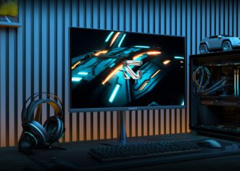 یک مانیتور گیمینگ Gigabyte GO27Q24 در یک محیط دسکتاپ گیمینگ، در کنار یک کیس کامپیوتر روشن، هدست و کیبورد مکانیکی.