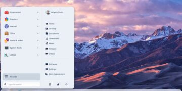 صفحه دسکتاپ سیستم عامل Zorin OS (لینوکس) با پس‌زمینه کوه‌های برفی و منوی شروع که برنامه‌های نصب شده و گزینه‌های دسکتاپ را لیست می‌کند.