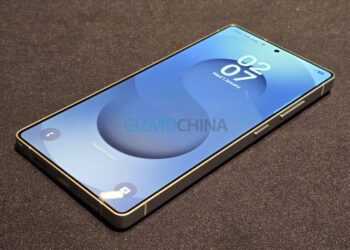 یک نمونه اولیه یا ماکت گوشی سامسونگ Galaxy S26 با لبه‌های تخت و براق و نمایشگر روشن که صفحه قفل آن ساعت و تاریخ را نشان می‌دهد.