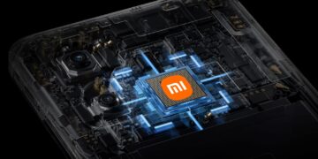 یک چیپست پردازنده شیائومی با لوگوی نارنجی رنگ Mi در مرکز، که در حالتی انفجاری در داخل یک گوشی هوشمند با نورپردازی آبی دیده میشود.