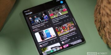 نمایشگر یک گوشی تاشو (Foldable) که فید ویدیوهای گوگل یا یوتیوب را با تصاویر بندانگشتی نشان میدهد.