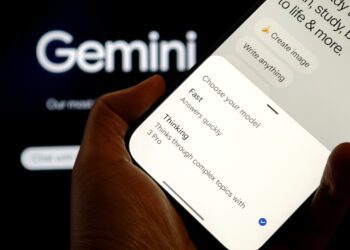 یک دست در حال نگه داشتن یک گوشی هوشمند با صفحه نمایش رابط کاربری Gemini 3، که گزینه‌های انتخاب مدل (Fast و 3 Pro) را نشان می‌دهد.
