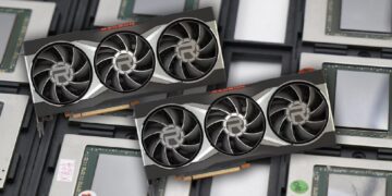 تصویر دو کارت گرافیک رادئون سه فن که روی مجموعه‌ای از تراشه‌های GPU چیده شده‌اند.