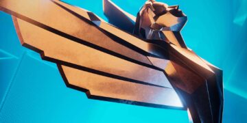 نمای نزدیک از تندیس نمادین The Game Awards با طراحی هندسی و رنگ طلایی، در پس‌زمینه آبی روشن و سبک گرافیکی رسمی مراسم