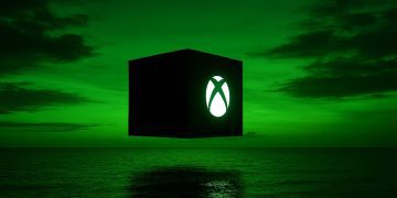 لوگوی درخشان ایکس‌باکس روی یک مکعب سیاه شناور بالای دریا در غروب سبز.