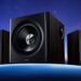 سابووفر و دو بلندگوی جانبی سیستم صوتی Edifier S201MKII با بدنه چوبی تیره، که روی یک پلتفرم آبی براق با پسزمینهای از ستارهها قرار دارند.