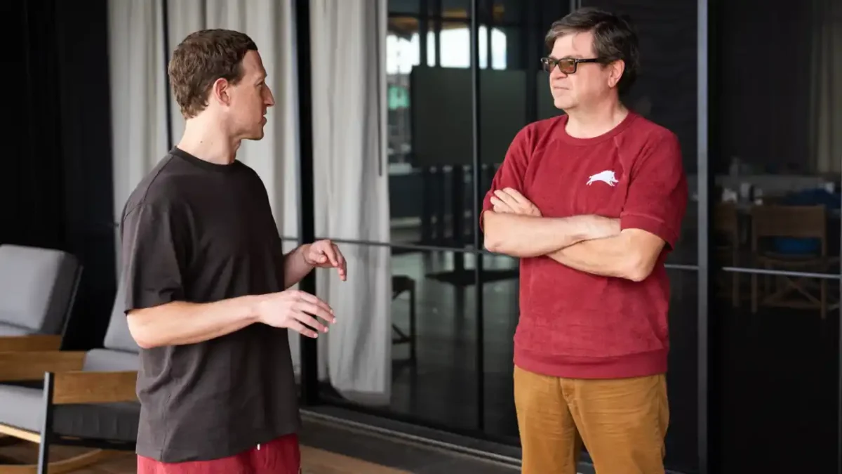 یان لکان (با تی‌شرت قرمز) و مارک زاکربرگ (مدیرعامل متا، با تی‌شرت مشکی) در حال گفت‌وگو در یک محیط بیرونی/لابی.