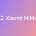 لوگوی سفید "Xiaomi MiMo" با یک آیکون جستجو/ستاره بر روی یک پس‌زمینه گرادیانتی بنفش و نارنجی.