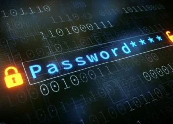 کلمه "Password" به رنگ آبی در یک کادر ورودی روی پس‌زمینه‌ای از کدهای باینری، که نماد قفل‌های باز و بسته شده نارنجی رنگ در دو طرف آن قرار دارند.
