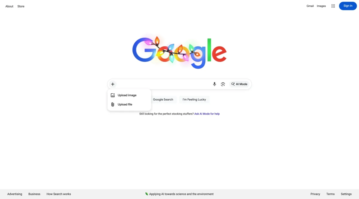 صفحه اصلی جستجوی گوگل با لوگوی تزیین شده، دکمه «AI Mode» و منوی جدید «+».