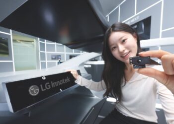 نمای دیگری از کارمند LG Innotek که ماژول حسگر دوربین را در محیط داخلی یک خودروی مدرن نشان می‌دهد.