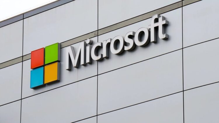 لوگوی چهاررنگ و نام شرکت مایکروسافت بر روی نمای بدنه یک ساختمان مدرن.