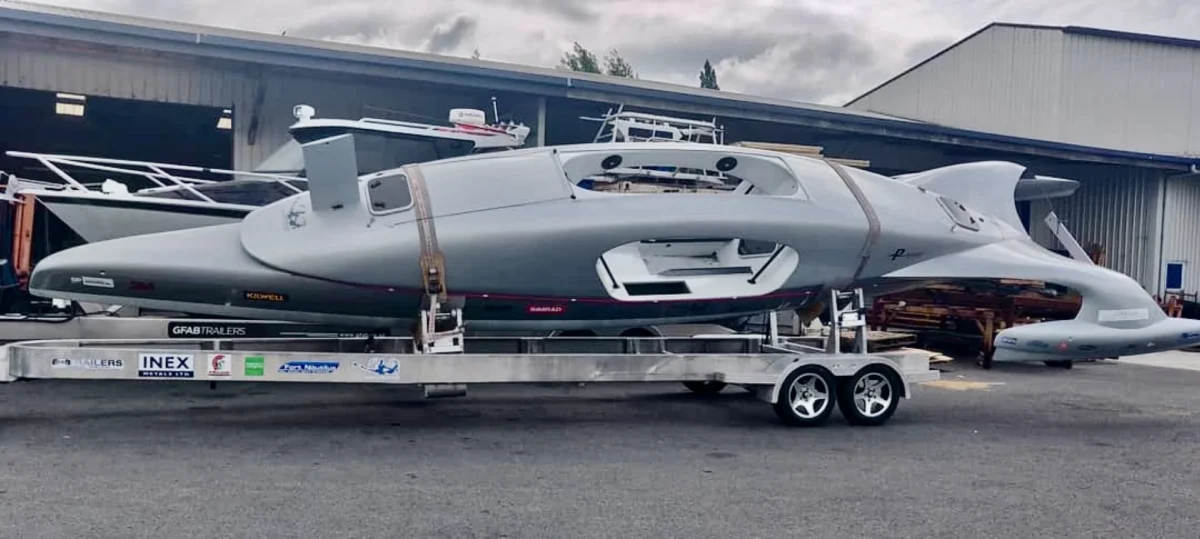 قایق پدالی اقیانوس‌پیما روی تریلر حمل‌ونقل زمینی، آماده انتقال بین بنادر در مسیر سفر به دور دنیا