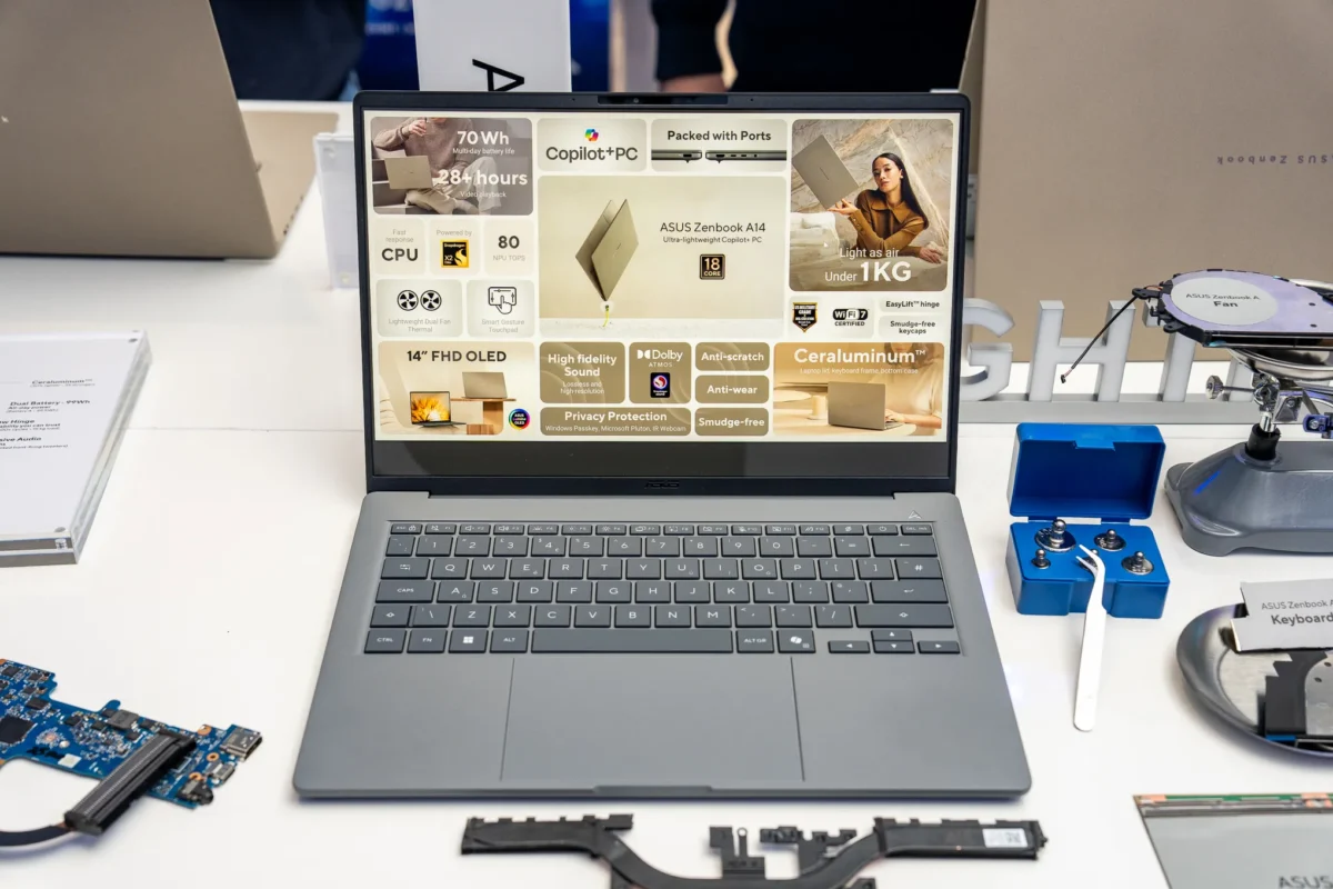 لپ‌تاپ خاکستری ASUS Zenbook A14 که ویژگی‌های فنی آن به صورت گرافیکی روی صفحه نمایش دیده می‌شود.