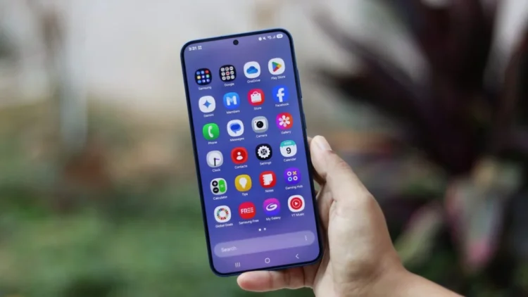 نمای صفحهنمایش Samsung Galaxy S25 Plus با رابط کاربری One UI 7 که کشوی اپلیکیشنها، آیکونهای پیشفرض سامسونگ و نوار جستوجو را نمایش میدهد.