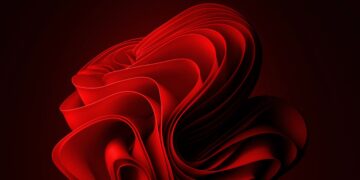 پسزمینه انتزاعی و مدرن ویندوز ۱۱ با لایههای منحنی به رنگ قرمز تیره.