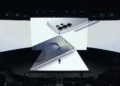 نمای صحنه رویداد Samsung Galaxy Unpacked 2025 با نمایشگرهای بزرگ که رندر مفهومی یک گوشی Galaxy Ultra Series، ماژول دوربین چندگانه، قلم S Pen و صفحهنمایش روشن با ساعت دیجیتال را نمایش میدهند.