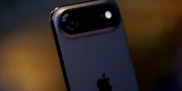 نمای کلوزآپ از پنل پشتی Apple iPhone Air با بدنه تیره، لبه‌های گرد، ماژول دوربین افقی کشیده شامل یک لنز اصلی و فلش LED، و لوگوی Apple در مرکز قاب؛ پس‌زمینه با افکت نور محو.