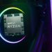نمای نزدیک از پردازنده AMD Ryzen نصب شده روی سیستم با نورپردازی رنگی دایره‌ای.