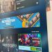 نمایی از رابط کاربری فروشگاه Steam روی نمایشگر، با بنر رویداد Steam Automation Fest در بالای صفحه و کارت‌های بازی مختلف در بخش پیشنهادها، شامل تخفیف‌ها و عناوین ویژه با طراحی گرافیکی صنعتی.