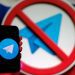 تصویر مفهومی از اپلیکیشن پیام‌رسان Telegram که روی صفحه یک گوشی هوشمند نمایش داده شده و در پس‌زمینه، نماد ممنوعیت (Prohibition Sign) روی لوگوی تلگرام دیده می‌شود. این تصویر به محدودسازی، فیلترینگ یا مسدودسازی تلگرام در یک کشور و چالش‌های دسترسی به پیام‌رسان‌ها اشاره دارد.