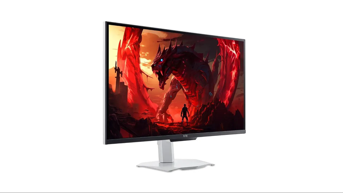 نمای زاویهدار از مانیتور گیمینگ Acer Nitro با پایه سفید، در حال نمایش تصویر پسزمینه فانتزی یک اژدهای قرمز در محیطی حماسی