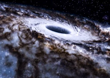 تصویرسازی هنری از سیاهچاله کلانجرم Sagittarius A* در مرکز کهکشان راه شیری با دیسک برافزایشی درخشان و ابرهای گازی پیرامون آن.