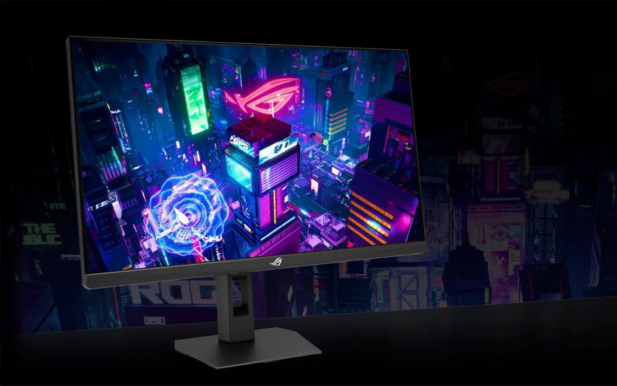 مانیتور گیمینگ ASUS ROG روی پایه مستطیلی در محیطی تاریک که تصویری نئونی از یک شهر آیندهنگر با رنگهای آبی، صورتی و بنفش را نمایش میدهد
