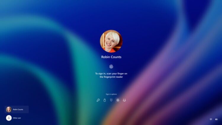 صفحه ورود سیستمعامل ویندوز با تصویر پروفایل کاربر که درخواست اسکن اثر انگشت (Windows Hello) برای لاگین را نمایش میدهد.