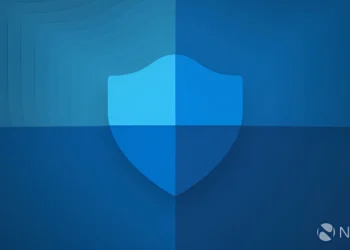 تصویر گرافیکی باکیفیت از آیکون سپر Windows Security که با سبک تخت و گرادینت‌های آبی طراحی شده و روی پس‌زمینه‌ای با طیف‌های مختلف رنگ آبی قرار گرفته است؛ لوگوی Neowin نیز در گوشه پایین سمت راست دیده می‌شود.