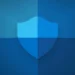 تصویر گرافیکی باکیفیت از آیکون سپر Windows Security که با سبک تخت و گرادینتهای آبی طراحی شده و روی پسزمینهای با طیفهای مختلف رنگ آبی قرار گرفته است؛ لوگوی Neowin نیز در گوشه پایین سمت راست دیده میشود.