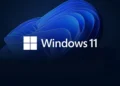 لوگوی سفید Windows 11 روی پس زمینه تیره با طرح انتزاعی و موجی آبی رنگ.