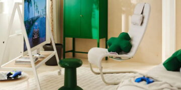 صندلی راحتی سفید مجموعه IKEA و Xbox با پشتی بلند، کوسن گردنی سفید و کوسن سبز، در کنار کابینت سبز و میز کوچکی با دسته بازی.