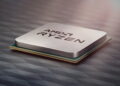 تصویر تبلیغاتی پردازنده AMD Ryzen با پوشش فلزی نقرهای روی یک سطح تیره با الگوی هندسی.
