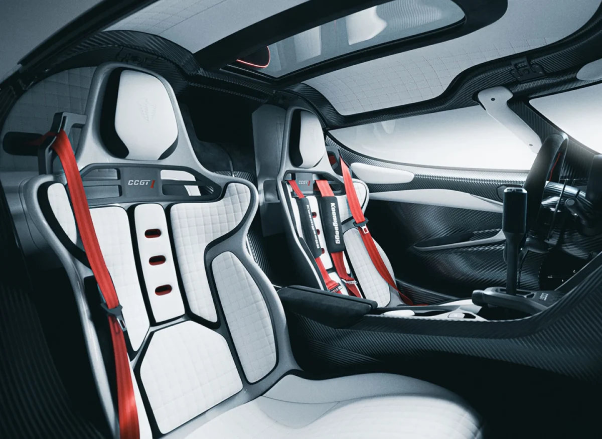 فضای داخلی Koenigsegg CCGT1 با صندلیهای مسابقهای سفید، کمربندهای قرمز و کابین فیبرکربنی