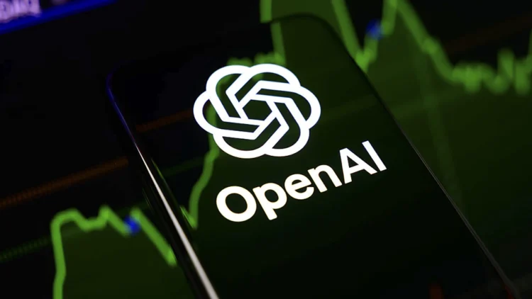 لوگوی شرکت OpenAI روی تلفن همراه در کنار نمودارهای مالی