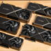 عکس محصول درآمده از شش کارت گرافیک انویدیا GeForce RTX 3090، 3080 Ti، 3080 و… با فن‌های دوتایی روی میز چوبی.
