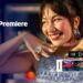 زن جوانی با لبخند و زیورآلات پرزرقوبرق و دستهای بالا برده در پسزمینه، با لوگوی قرمز Adobe Premiere در سمت چپ و المان رابط کاربری تایملاین ویدیو با دکمههای کنترل پخش در پیشزمینه.