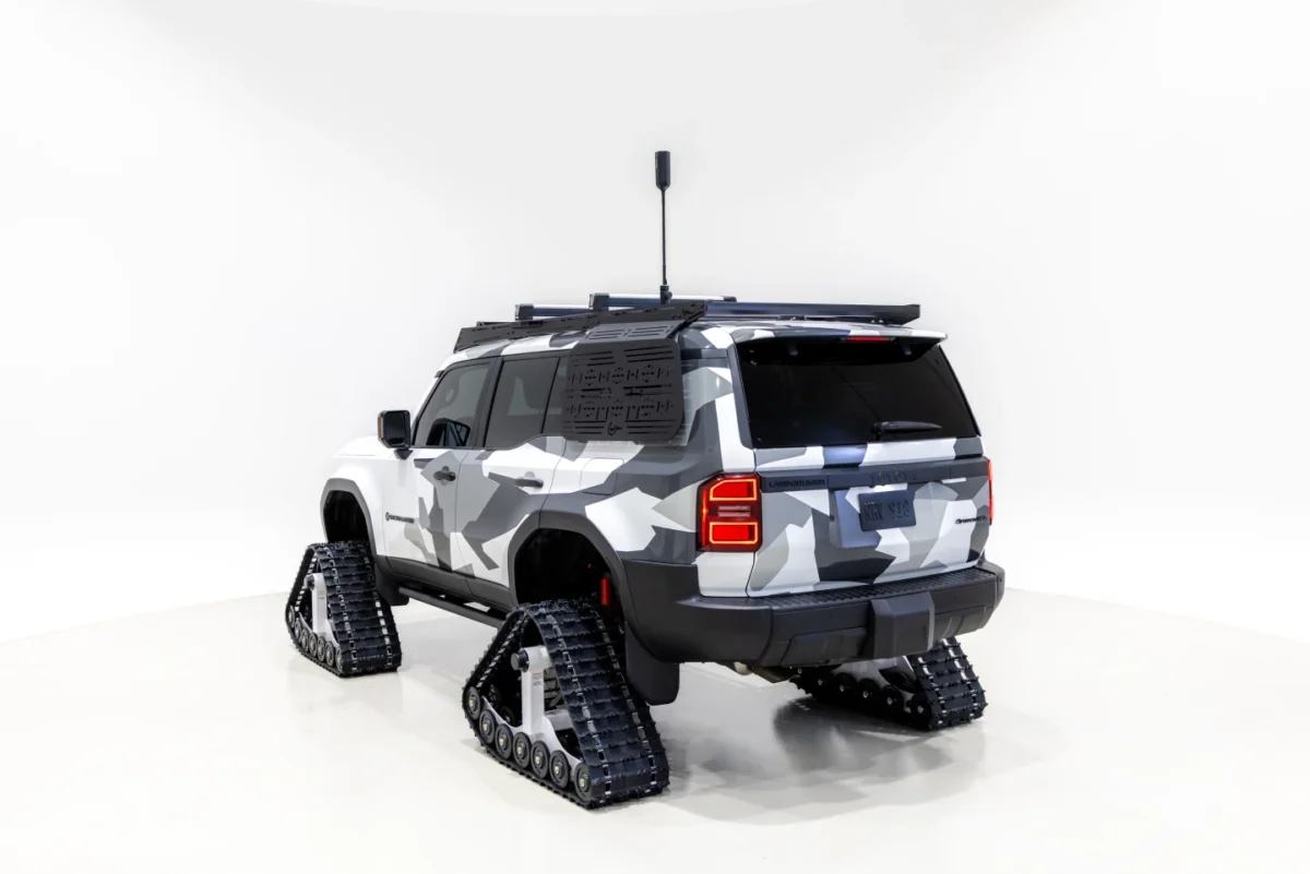 نمای عقب Toyota 4Runner Snowhunter با چهار شنی لاستیکی، باربند سقفی و جعبه حمل تجهیزات در محیط نمایشگاهی