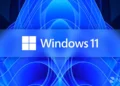 تصویر شاخص ویندوز ۱۱: لوگوی سفیدرنگ چهارخانه‌ی مایکروسافت در کنار واژه‌ی «Windows 11» روی یک نوار افقی آبی بلوری در مرکز کادر نشسته است. پس‌زمینه پس‌زمینه‌ی رسمی «Bloom» ویندوز ۱۱ است؛ الگویی متقارن و گل‌مانند از پرده‌های موج‌دار و رشته‌های نوری آبی و سرمه‌ای که از مرکز به بیرون باز شده‌اند. واترمارک «Neowin» در گوشه‌ی پایین سمت راست دیده می‌شود.