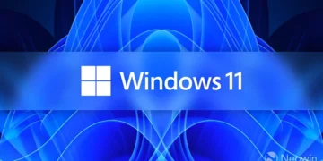 تصویر شاخص ویندوز ۱۱: لوگوی سفیدرنگ چهارخانهی مایکروسافت در کنار واژهی «Windows 11» روی یک نوار افقی آبی بلوری در مرکز کادر نشسته است. پسزمینه پسزمینهی رسمی «Bloom» ویندوز ۱۱ است؛ الگویی متقارن و گلمانند از پردههای موجدار و رشتههای نوری آبی و سرمهای که از مرکز به بیرون باز شدهاند. واترمارک «Neowin» در گوشهی پایین سمت راست دیده میشود.