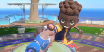 نمایی از بازی Nintendo Switch Sports Resort و مسابقهی مچاندازی روی میز، با شخصیتی با موهای قهوهای در برابر دست کاربر با کنترلر آبی.