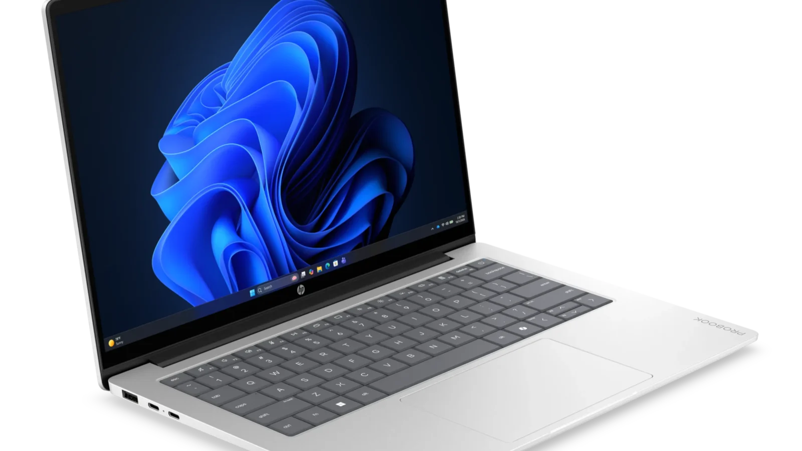 لپ‌تاپ نقره‌ای رنگ HP ProBook روی میز با صفحه‌نمایش روشن و تصویر زمینه موج‌های آبی رنگ ویندوز ۱۱.